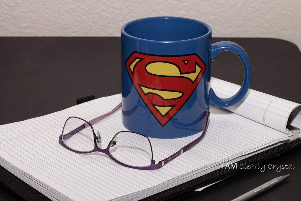 mug and glasses on a notepad