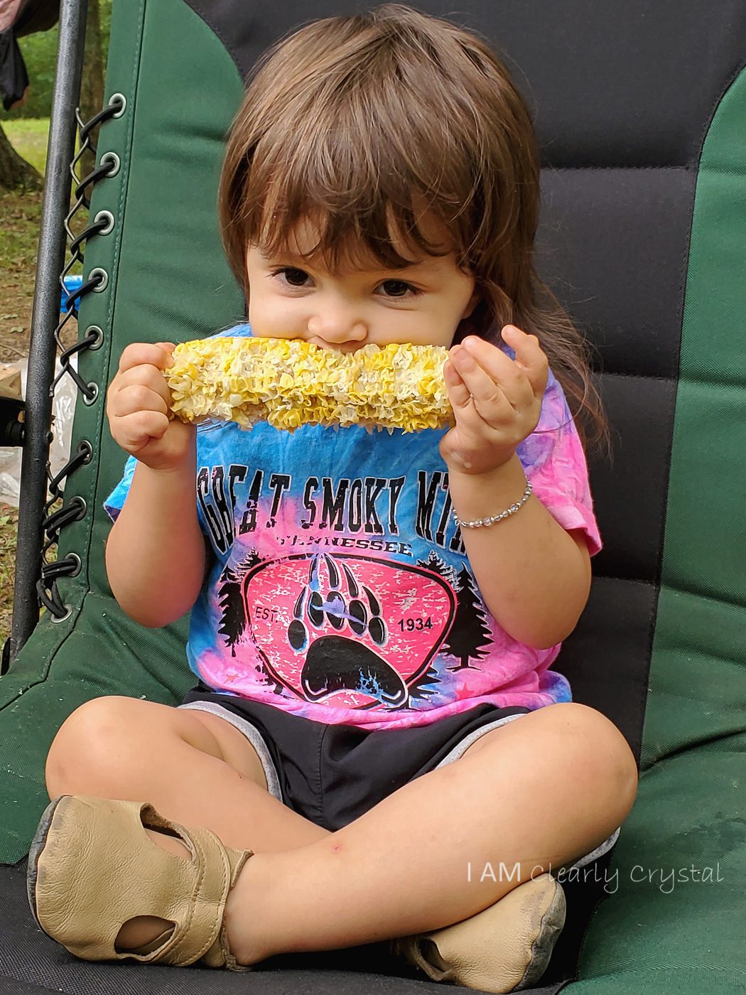 granddaughter eating corn on cob