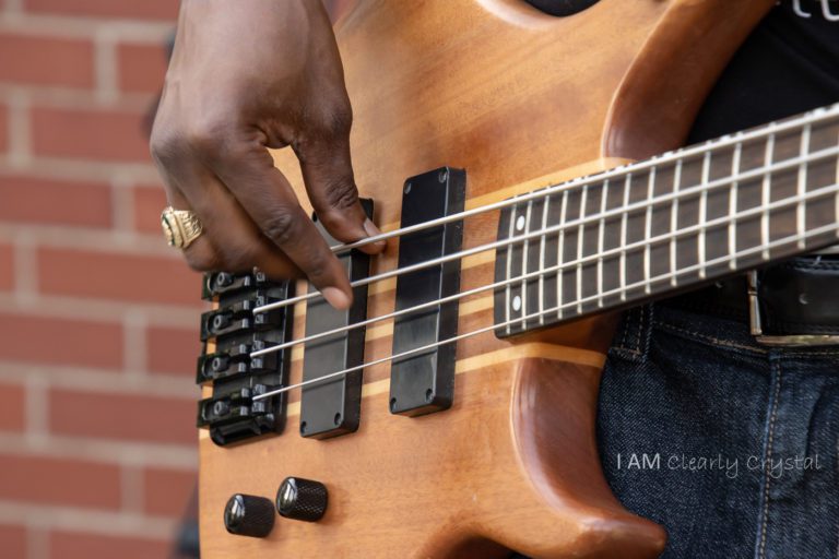 fingers strumming electric guitar